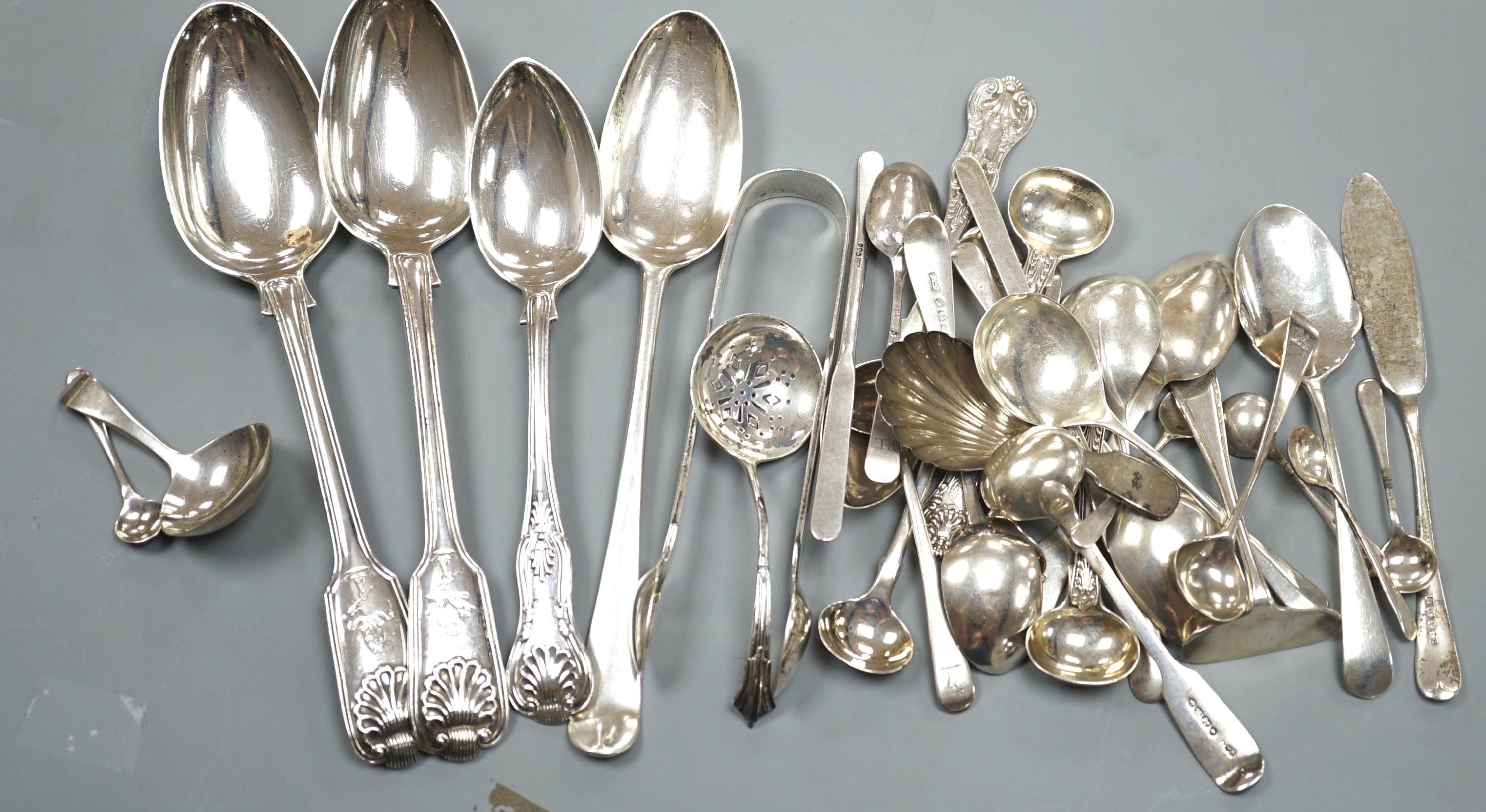 A quantity of assorted mainly 19th century and later flatware, including two Georgian caddy spoons, Victorian tablespoons, an 18th century tablespoon and assorted condiment spoons, various dates and maker's